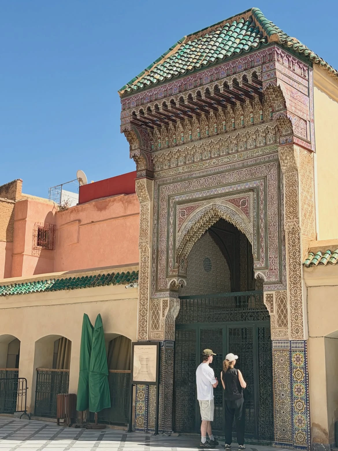 Ornate Moroccan archway framing a minaret in an imperial city